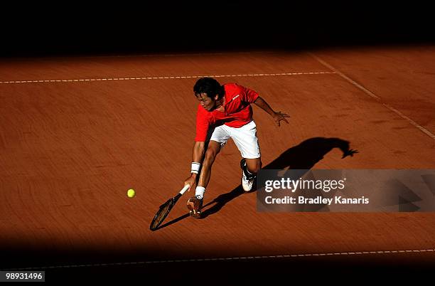 Tatsuma Ito of Japan plays a backhand during his match against Carsten Ball of Australia during the match between Australia and Japan on day three of...