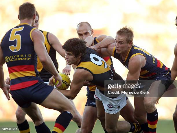 Trent Cotchin of the Tigers is surrounded by Crows players during the round seven AFL match between the Adelaide Crows and the Richmond Tigers at...