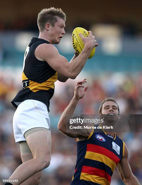 Jack Riewoldt of the Tigers takes a mark in front of Ben Rutten of the Crows during the round seven AFL match between the Adelaide Crows and the...