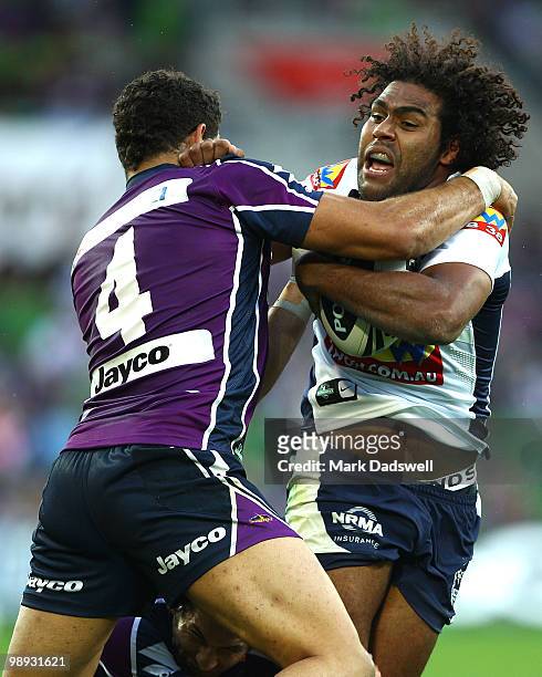 Greg Inglis of the Storm tackles Sam Thaiday of the Broncos during the round nine NRL match between the Melbourne Storm and the Brisbane Broncos at...