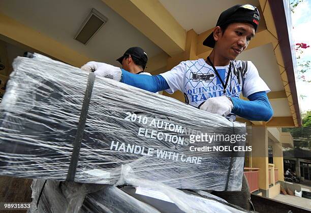 Worker loads ballot papers into a truck to be transported to precints during the final testing and sealing of automated election counting machines a...
