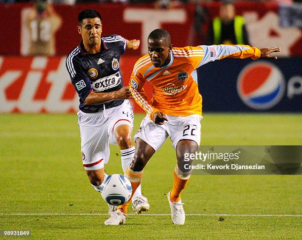 Lovel Palmer of Houston Dynamo in action against Michael Umana of Chivas USA during the second half of the MLS soccer game on May 8, 2010 at the Home...