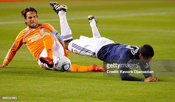 Mike Chabala of Houston Dynamo tackles Dario Delgado of Chivas USA during first half action of the MLS soccer match on May 8, 2010 at the Home Depot...