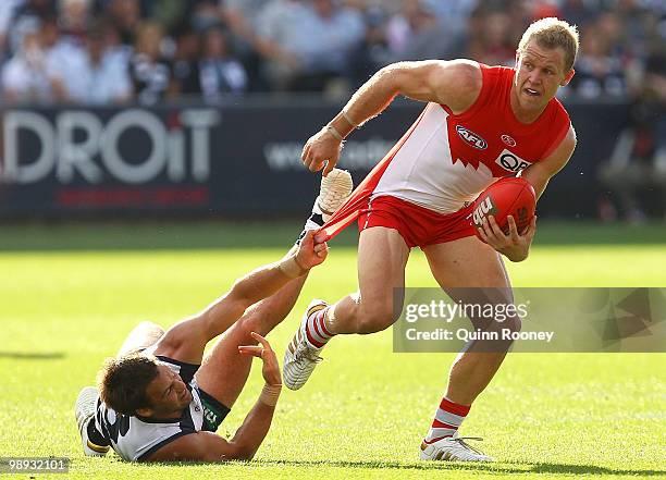 Ryan O'Keefe of the Swans is tackled by Jimmy Bartel of the Cats during the round seven AFL match between the Geelong Cats and the Sydney Swans at...