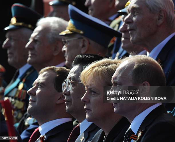 Russian President Dmitry Medvedev , Chinese President Hu Jintao , German Chancellor Angela Merkel and Russian Prime Minister Vladimir Putin watch the...
