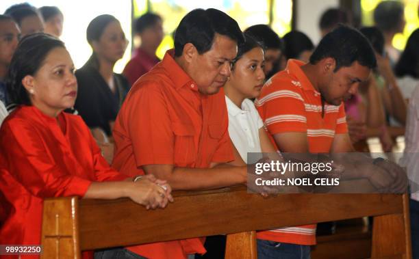 Presidential candidate and senator Manuel Villar attends a mass with his family at a church in Las Pinas, south of Manila on May 9, 2010. More than...