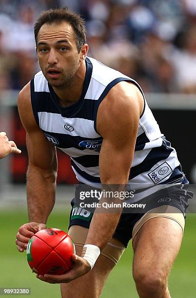 James Podsiadly of the Cats handballs during the round seven AFL match between the Geelong Cats and the Sydney Swans at Skilled Stadium on May 9,...