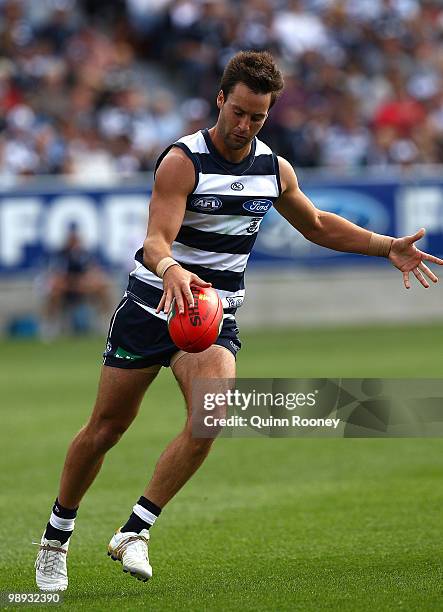Jimmy Bartel of the Cats handballs during the round seven AFL match between the Geelong Cats and the Sydney Swans at Skilled Stadium on May 9, 2010...