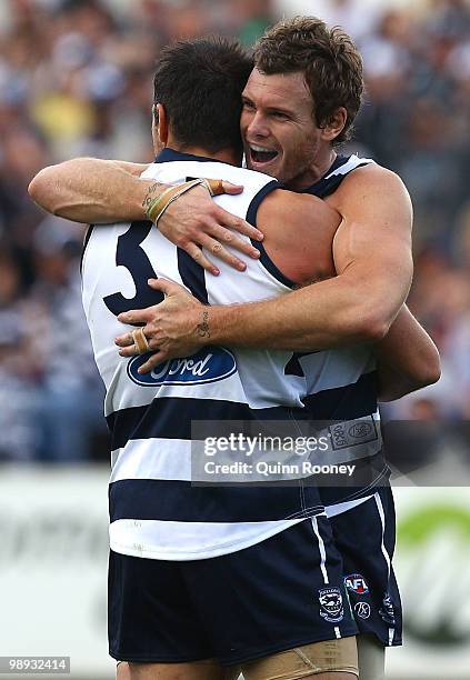 James Podsiadly and Cameron Mooney of the Cats celebrate a goal during the round seven AFL match between the Geelong Cats and the Sydney Swans at...