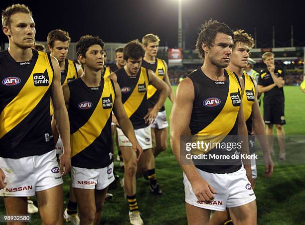 Tigers players leave the field after losing the game during the round seven AFL match between the Adelaide Crows and the Richmond Tigers at AAMI...