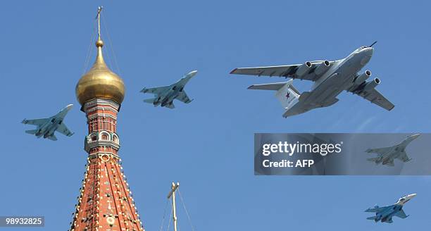 Russian A-50 plane and Su-27 fighter jets fly over St. Basil's cathedral during the Victory Day parade in Moscow on May 9, 2010. In a moment of huge...