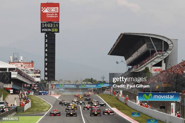 Mark Webber of Australia and Red Bull Racing leads team mate Sebastian Vettel of Germany and Red Bull Racing and the rest of the field down towards...