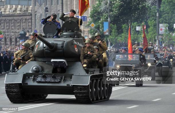 Soviet Military machinery of WWII headed by legendary soviet T-34 battle tank roll by Khreshchatyk Street during the Victory Day military parade,...