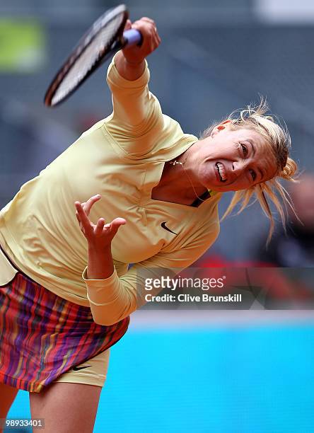 Maria Sharapova of Russia serves during her straight sets defeat by Lucie Safarova of Czech Republic in their first round match during the Mutua...