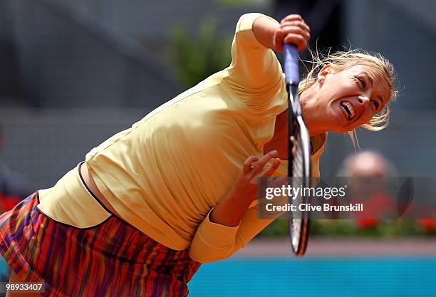 Maria Sharapova of Russia serves during her straight sets defeat by Lucie Safarova of Czech Republic in their first round match during the Mutua...