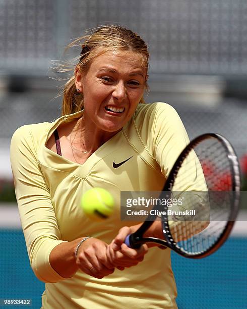 Maria Sharapova of Russia plays a backhand during her straight sets defeat by Lucie Safarova of Czech Republic in their first round match during the...