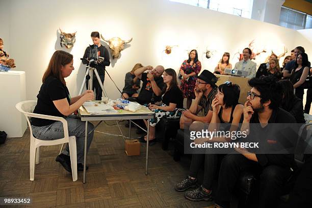 Taxidermy artist Jeanie M demonstrates how to skin and taxidermy a mouse at the Rogue Taxidermy Show at the La Luz de Jesus Gallery in Los Angeles on...