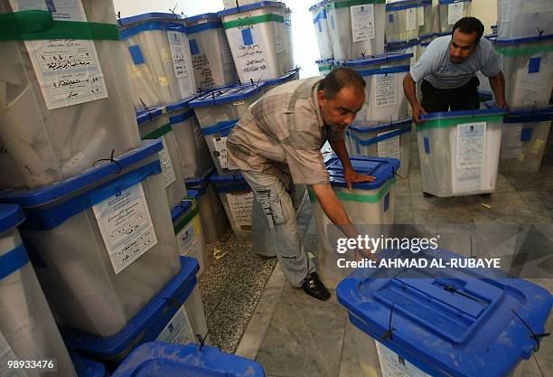 Iraqi electoral staff member arrange ballot boxes after votes were recounted in Baghdad on May 9, 2010. The electoral commission has sent results...