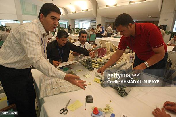 Iraqi electoral staff recount ballots in Baghdad on May 9, 2010. The electoral commission has sent results from 17 of Iraq's provinces in its March 7...