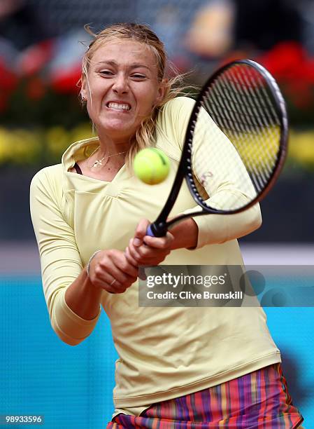 Maria Sharapova of Russia plays a backhand during her straight sets defeat by Lucie Safarova of Czech Republic in their first round match during the...