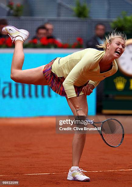 Maria Sharapova of Russia serves during her straight sets defeat by Lucie Safarova of Czech Republic in their first round match during the Mutua...