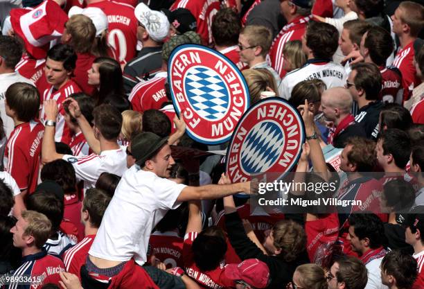 Fans celebrate as they wait at the town hall sqaure for the players of Bayern Muenchen to present the German championship trophy on the balcony of...