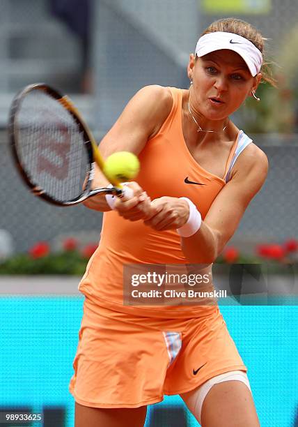 Lucie Safarova of Czech Republic plays a backhand against Maria Sharapova of Russia in their first round match during the Mutua Madrilena Madrid Open...