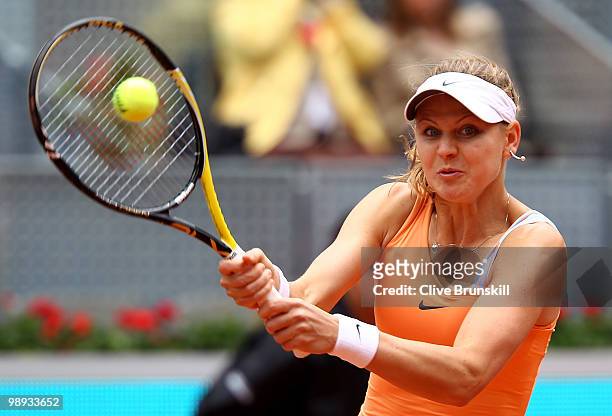 Lucie Safarova of Czech Republic plays a backhand against Maria Sharapova of Russia in their first round match during the Mutua Madrilena Madrid Open...