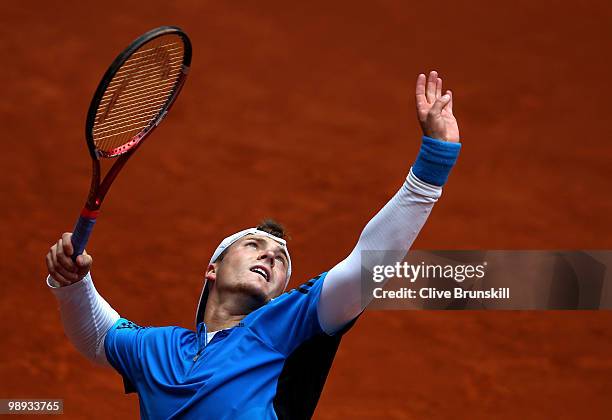 Evgeny Korolev of Kazakstan serves against Ivo Karlovic of Croatia in their first round match during the Mutua Madrilena Madrid Open tennis...