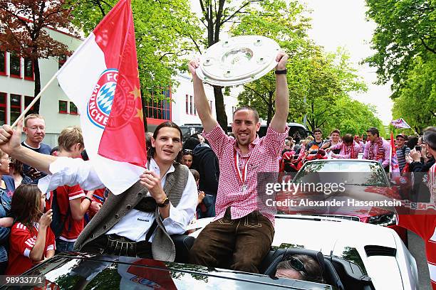 Franck Ribery and his team mate Daniel van Buyten celebrate the German championship with the trophy on the way to the champions party at the...
