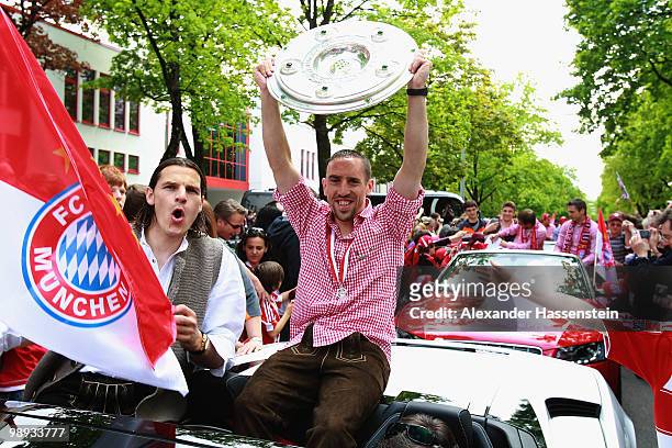 Franck Ribery and his team mate Daniel van Buyten celebrate the German championship with the trophy on the way to the champions party at the...