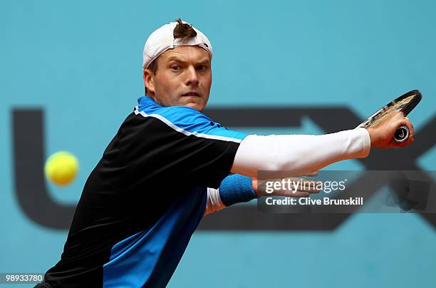 Evgeny Korolev of Kazakstan plays a backhand against Ivo Karlovic of Croatia in their first round match during the Mutua Madrilena Madrid Open tennis...