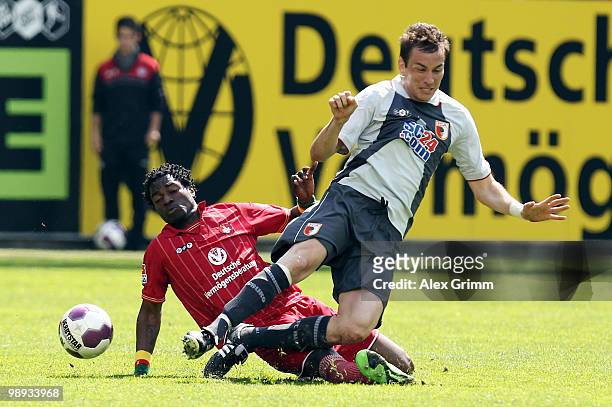 Goran Sukalo of Augsburg is challenged by Georges Mandjeck of Kaiserslautern during the Second Bundesliga match between 1. FC Kaiserslautern and FC...