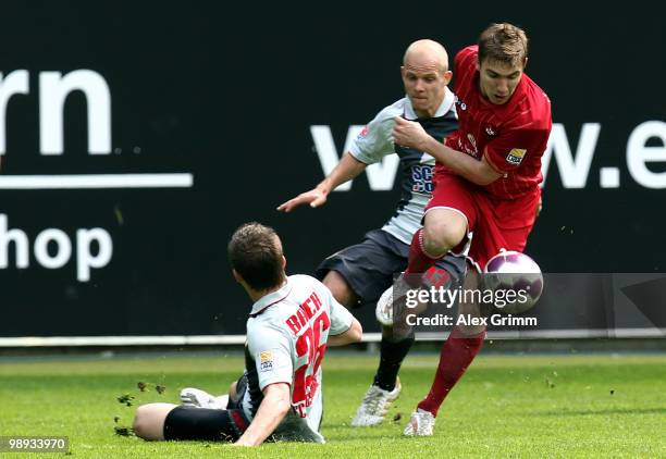 Erik Jendrisek of Kaiserslautern is challenged by Tobias Werner and Daniel Baier of Augsburg during the Second Bundesliga match between 1. FC...