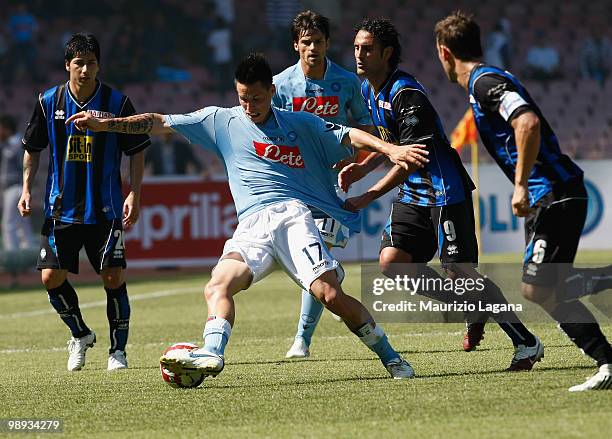 Marek Hamsik of SSC Napoli battles for the ball with Nicola Amoruso of Atalanta BC during the Serie A match between SSC Napoli and Atalanta BC at...