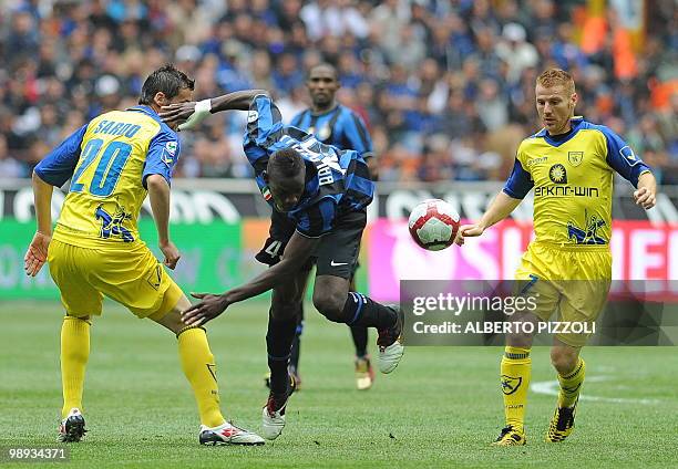 Inter Milan's forward Mario Balotelli fights for the ball with Chievo defender Angelo gennaro and midfielder Michele Marcolini during their Italian...