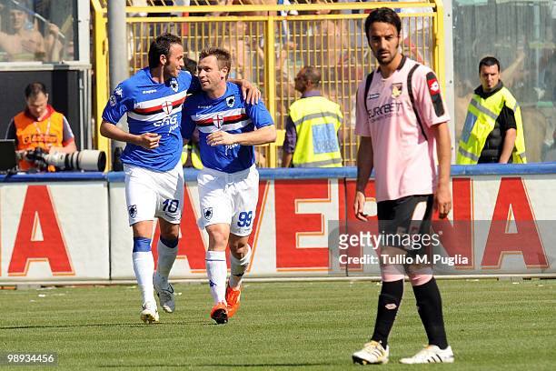 Gampaolo Pazzini of Sampdoria celebrates with his team mate Antonio Cassano after scoring the opening goal as Mattia Cassani of Palermo looks on...