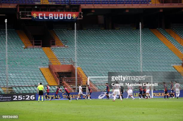 Players of Genoa CFC and players of AC Milan play in a empty stadium under a banner remembering Claudio Spagnolo, a fan of Genoa CFC, who was killed...