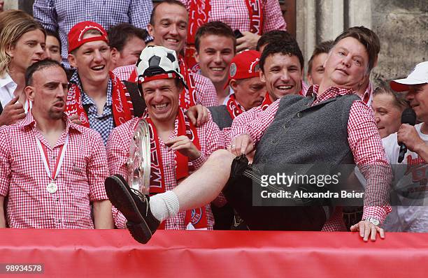 Head coach Louis van Gaal of Bayern Muenchen shows his traditional Bavarian outfit as the team celebrates their German championship title on the...