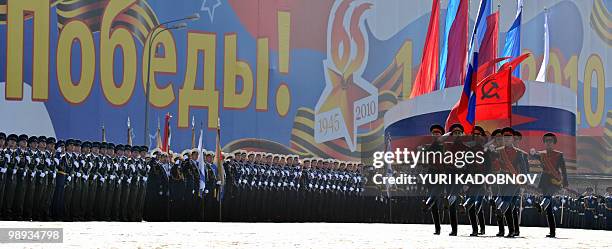 Russian soldiers carry the Soviet victory flag through Red Square during the Victory Day parade in Moscow May 9, 2010. Troops from four NATO states...