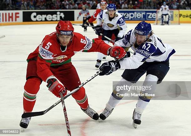 Nikolai Stasenko of Belarus and Vadim Krasnoslabodtsev of Kazakhstan battle for the puck during the IIHF World Championship group A match between...