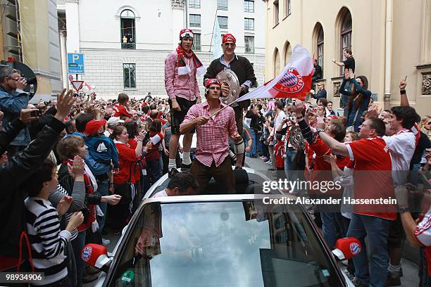 Bastian Schweinsteiger of Bayern Muenchen, his team mates Holger Badstuber and Mario Gomez celebrate the German championship with the trophy on the...