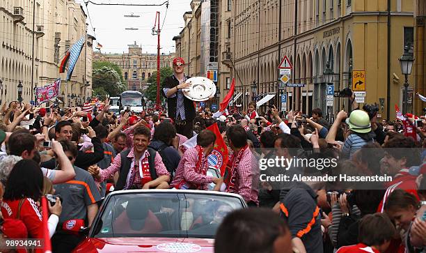 Bastian Schweinsteiger of Bayern Muenchen celebrates the German championship with the trophy on the way to the champions party at the Marienplatz on...