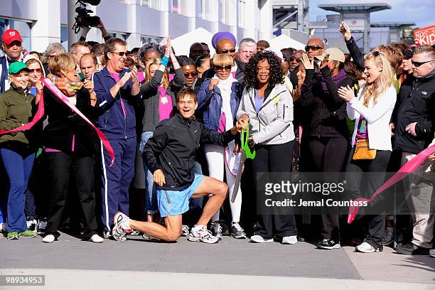 Media personality and physician Dr. Mehmet Oz and media personality Oprah Winfrey cut the ribbon to signal the start of the "Live Your Best Life...