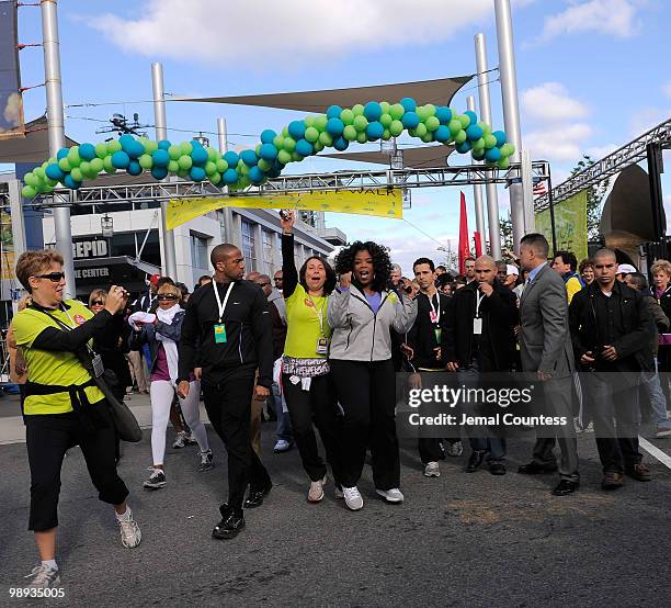 Media personality Oprah Winfrey jumps in celebration at the start of the "Live Your Best Life Walk" to celebrate O, The Oprah Magazine's 10th...