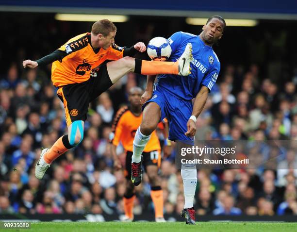 James McCarthy of Wigan Athletic battles with Didier Drogba of Chelsea during the Barclays Premier League match between Chelsea and Wigan Athletic at...