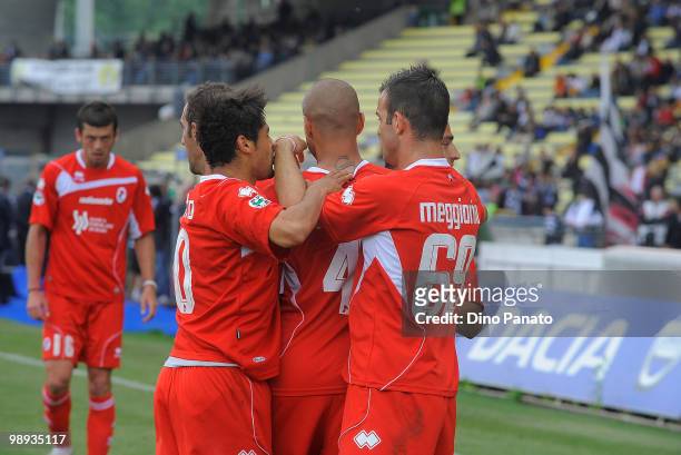 Goalscorer Bernardo Sergio Almiron of AS Bari is congratulated by Riccardo Meggiorini and teammates during the Serie A match between Udinese Calcio...