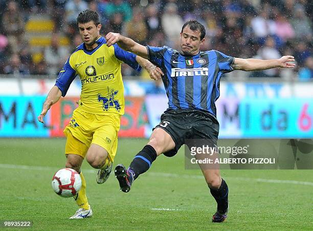 Inter Milan's Serbian midfielder Dejan Stankovic fights for the ball with Chievo midfielder Manuel Iori during their Italian serie A football match...