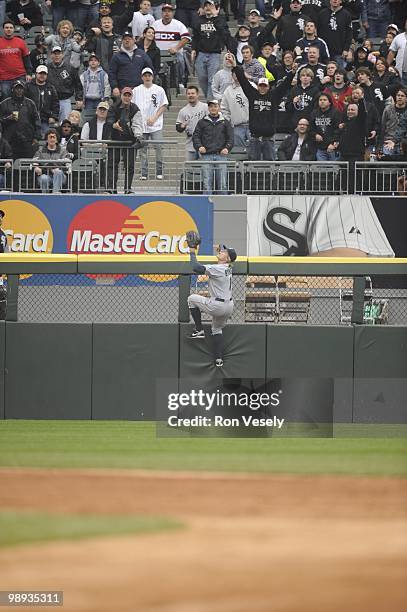 Eric Byrnes of the Seattle Mariners leaps but cannot catch the ball hit by Alexei Ramirez of the Chicago White Sox during the fifth inning on April...