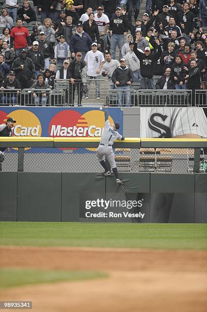 Eric Byrnes of the Seattle Mariners leaps but cannot catch the ball hit by Alexei Ramirez of the Chicago White Sox during the fifth inning on April...